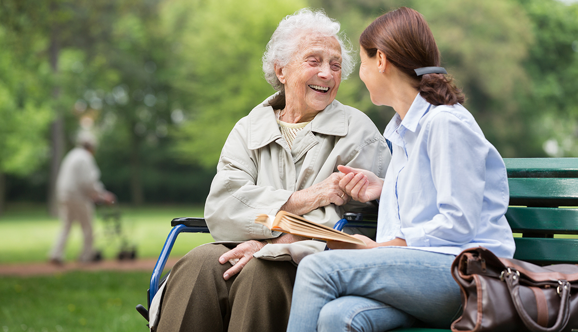 Senior woman with caregiver in the park